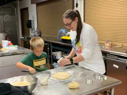 a person and a boy preparing food