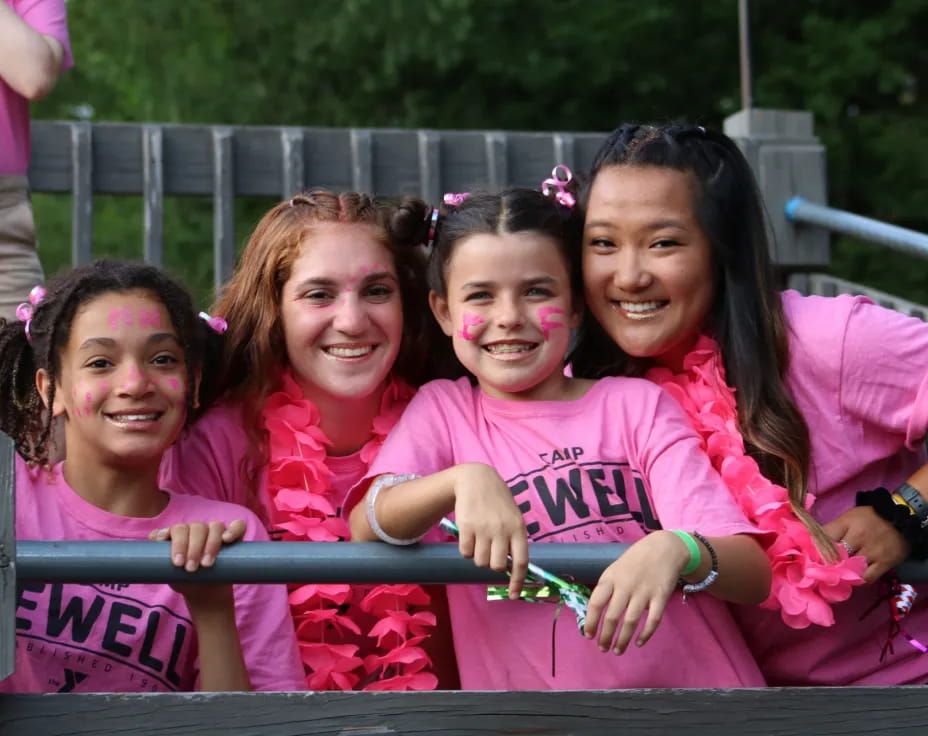 a group of girls in pink shirts