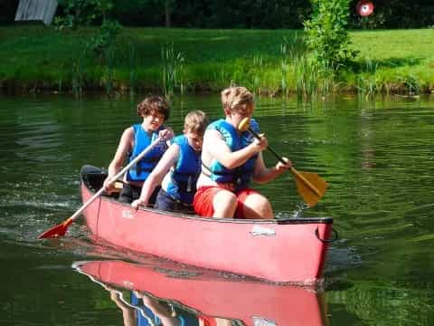 a group of boys in a canoe