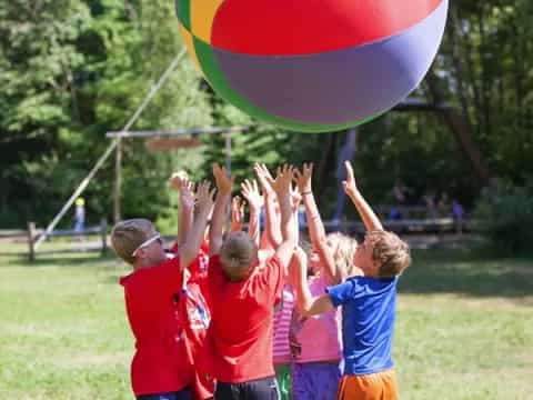 a group of kids playing with a large balloon