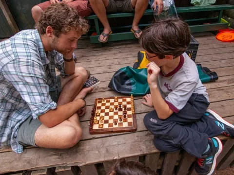 a person and a child playing chess