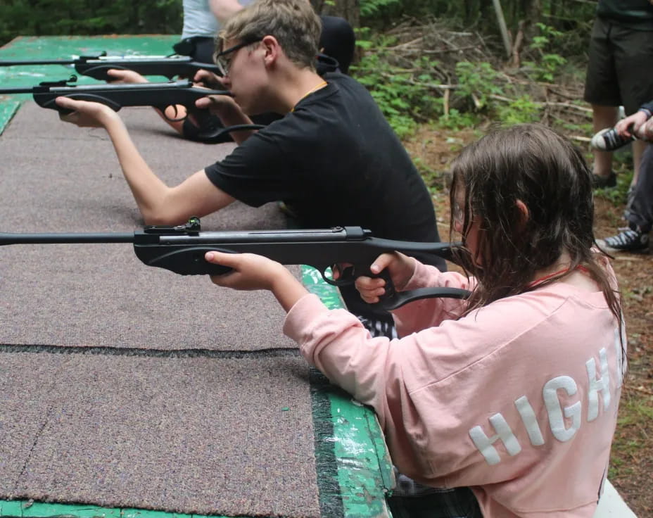 a man and a woman shooting guns