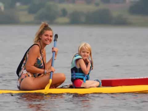 a woman and a child in a canoe