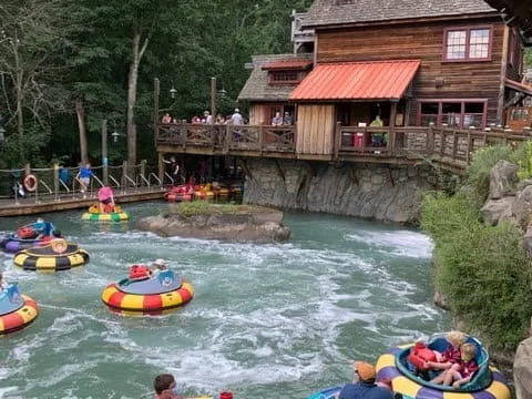 a group of people in inner tubes on a river