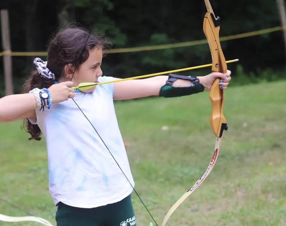 a girl holding a bow and arrow