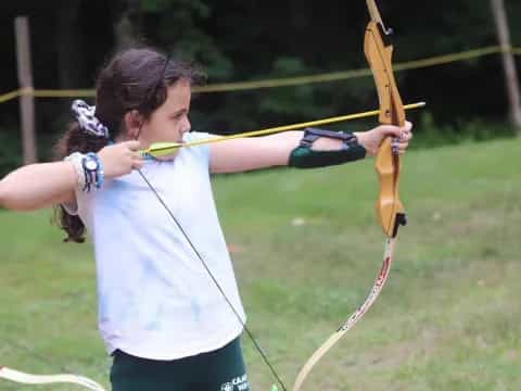 a girl holding a bow and arrow