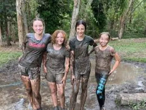 a group of people in mud