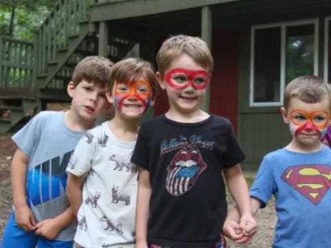 a group of boys wearing face paint