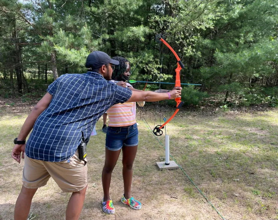 a man and woman shooting bows