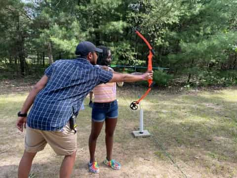 a man and woman shooting bows