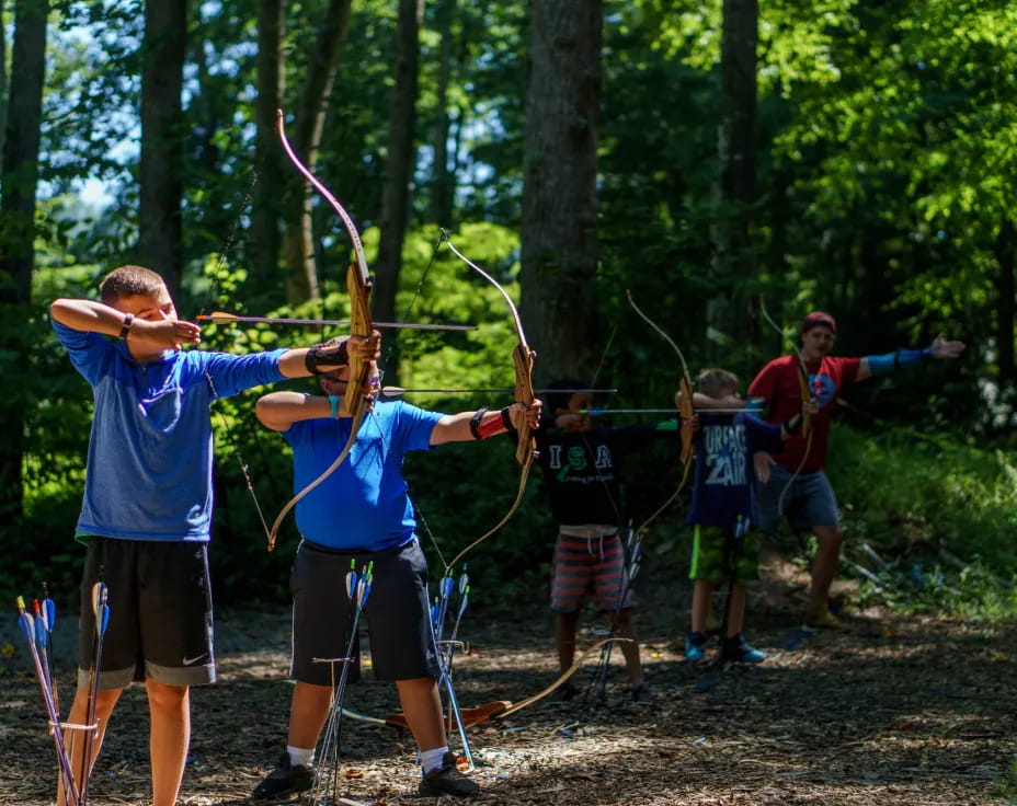 a group of people shooting bows