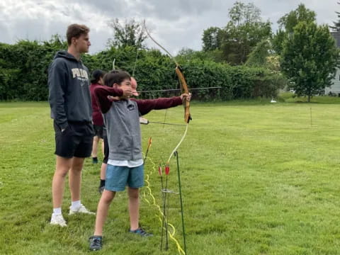 a group of people playing with bows and arrows