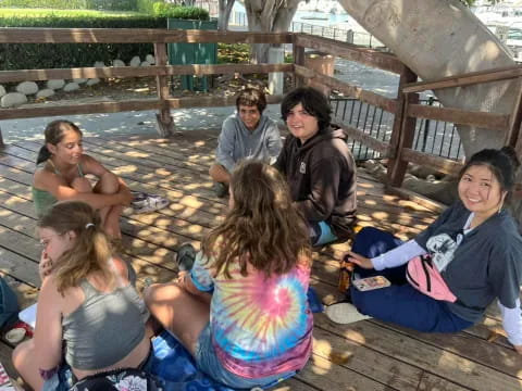 a group of people sitting on a deck