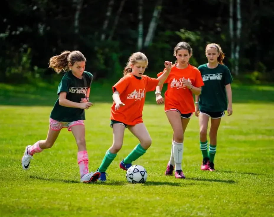 a group of girls playing football