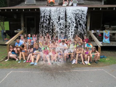 a group of people posing for a photo in front of a fountain