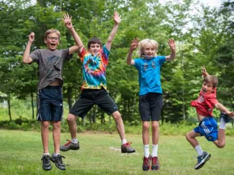 a group of kids jumping in the air