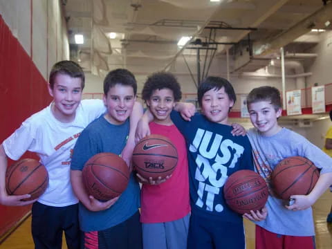 a group of boys holding basketballs