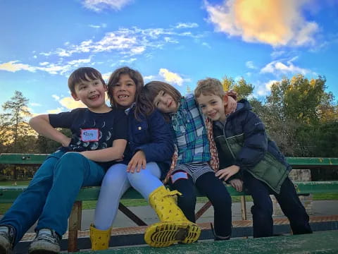 a group of people sitting on a bench