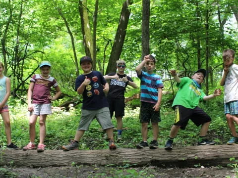 a group of people posing for a photo in the woods
