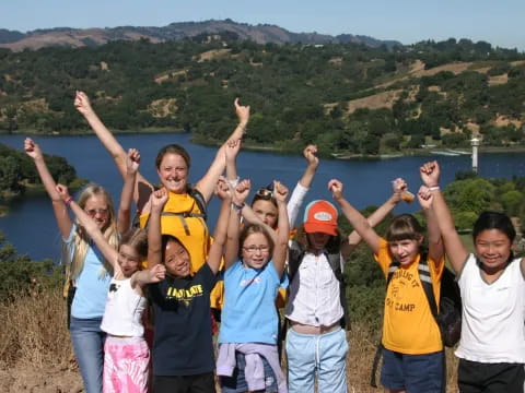 a group of people posing for a photo with their arms raised