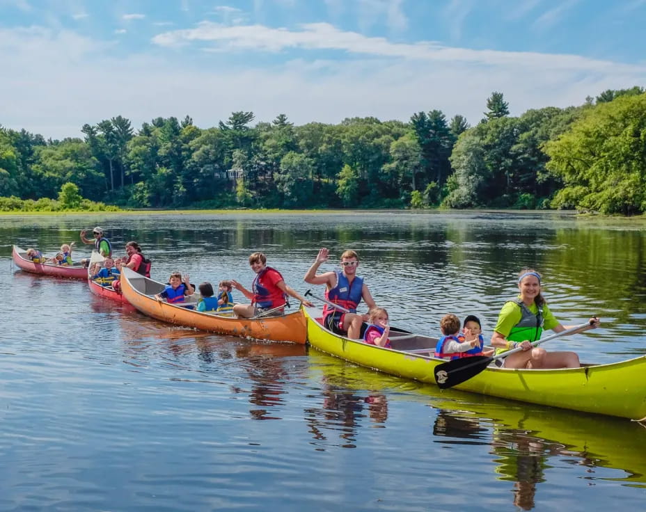 a group of people in canoes on a river