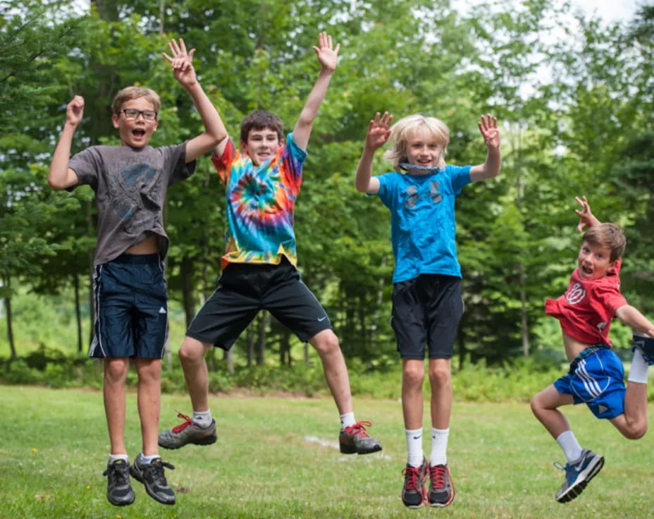 a group of kids jumping in the air
