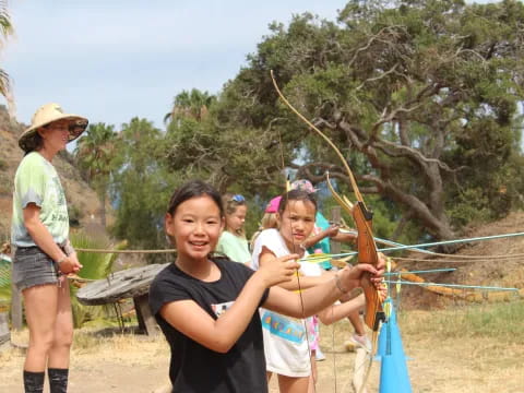 a group of people holding bows and arrows