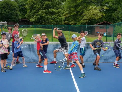 a group of kids holding tennis rackets