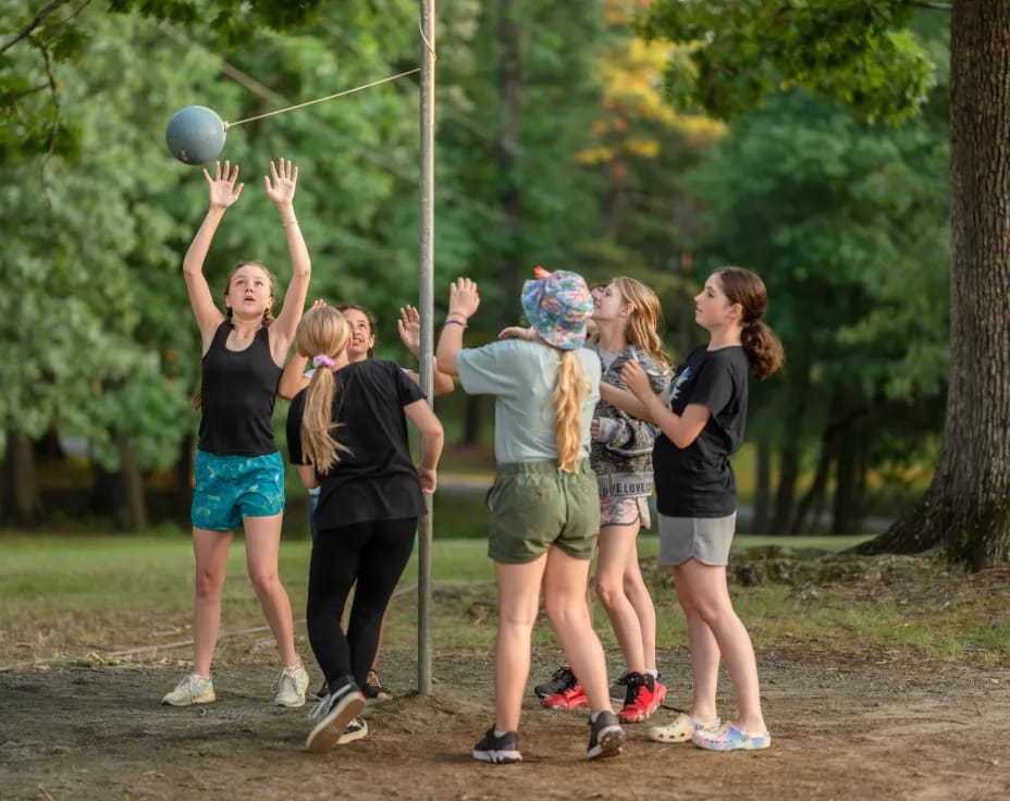 a group of girls playing with a ball