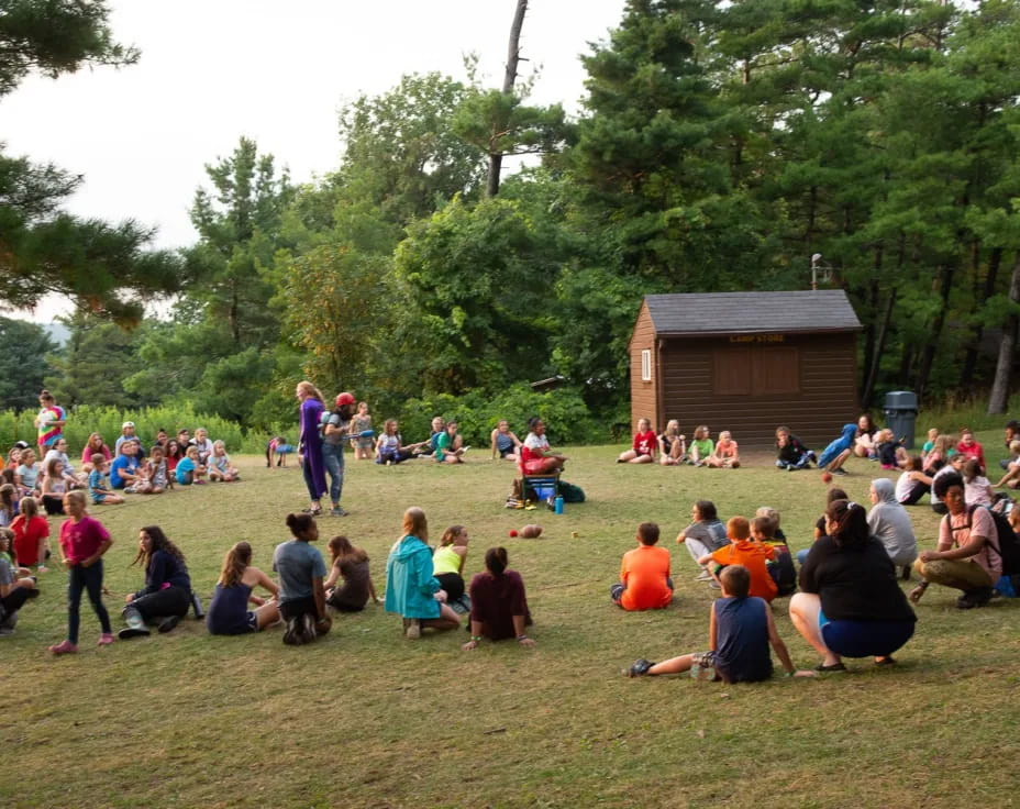 a group of people sitting on the ground outside