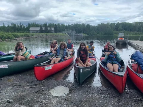 a group of people in canoes on a lake