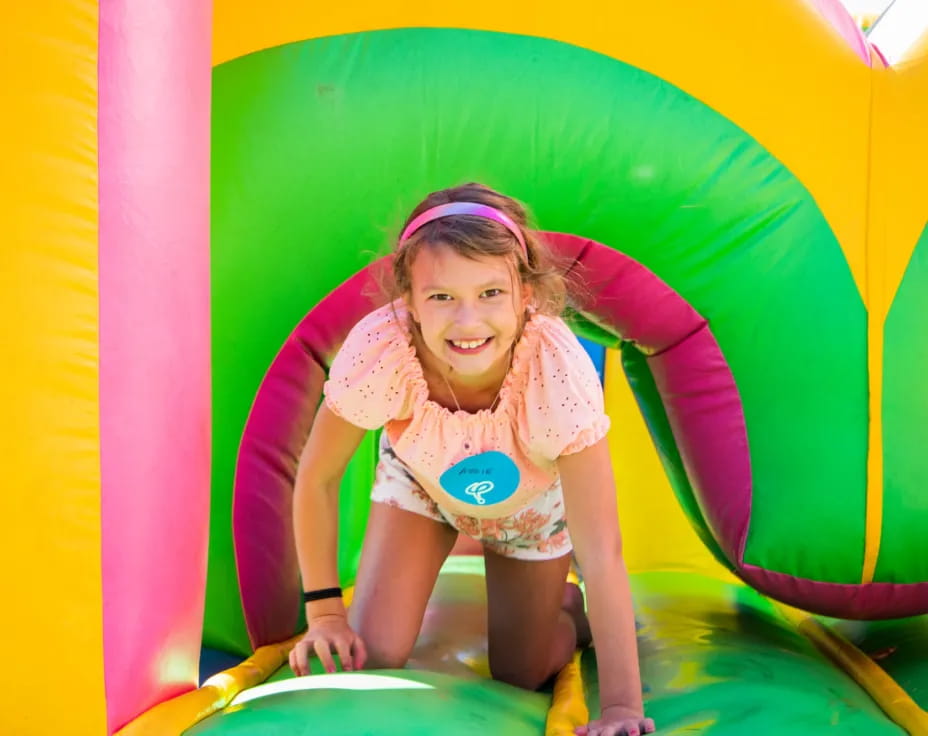 a girl in a pink shirt in a water slide