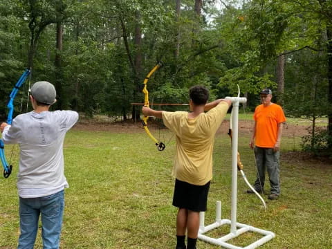 a group of people shooting bows