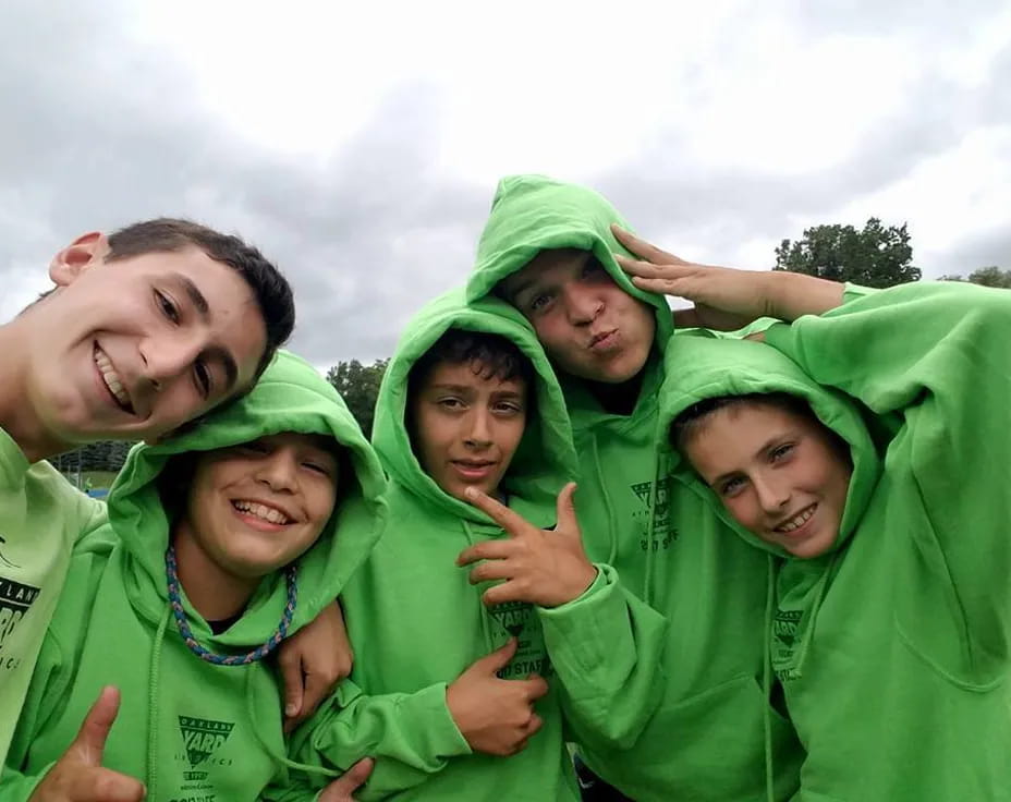 a group of people wearing green shirts