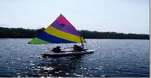 a boat with a colorful parachute