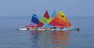 a boat with colorful sails