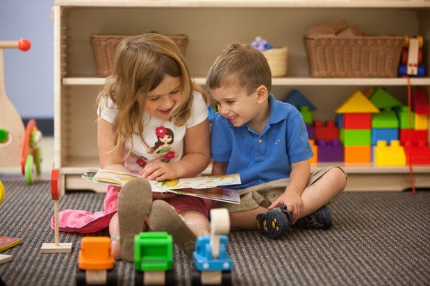 a boy and girl playing with toys