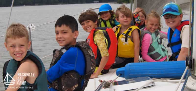 a group of kids in a boat