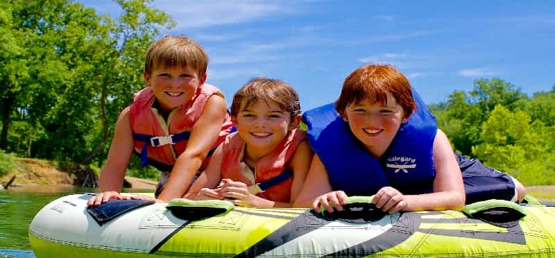 a group of kids in a raft