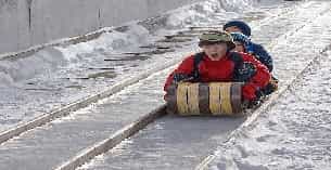 a group of kids on a sled in the snow