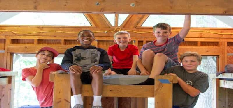 a group of kids sitting on a bench