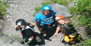 a group of kids wearing helmets and harnesses