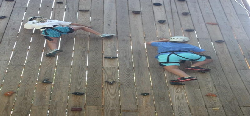 a group of people dancing on a wooden deck