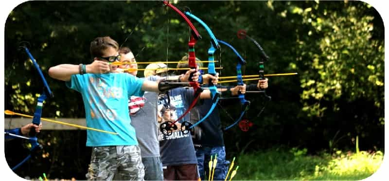 a group of people holding bows and arrows