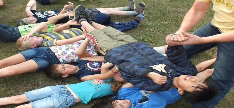 a group of people lying on the grass