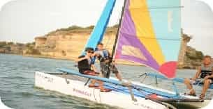 a group of people on a sailboat in the water