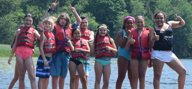 a group of people posing for a photo in the water