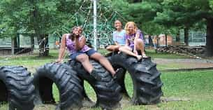 a group of people sitting on a large black cannon