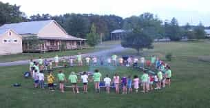 a group of people standing in a circle in a circle outside