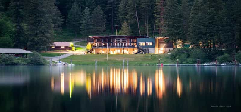 a house on a hill by a lake